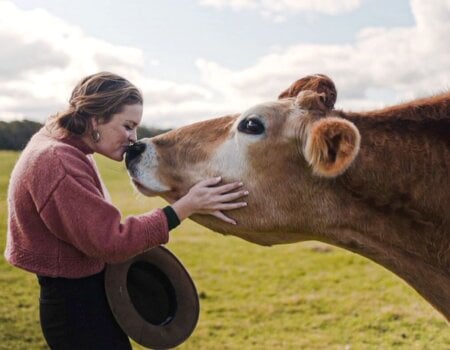 Katie White Kissing a cow on the nose