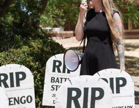 Activist stands with horse "graves"