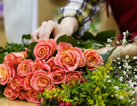 A photo of flowers being arranged on a table.