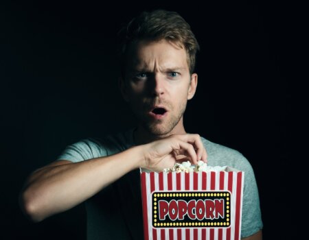 a man eating popcorn.