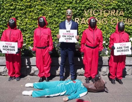 Activists recreate a scene from Squid Game at the gates of Flemington