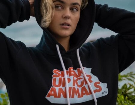 Stefania wears a hoodie that reads "Speak up for animals".