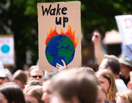 Image of a poster that says "Wake Up" at a Climate Strike protest.